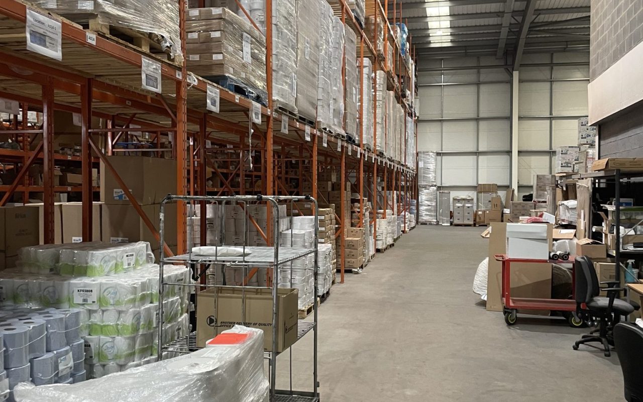 Warehouse shelves stacked with boxed goods