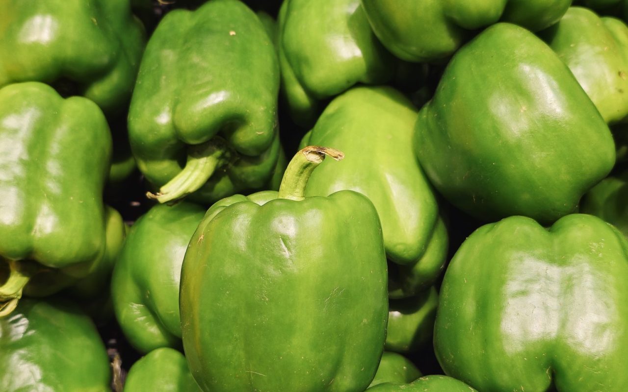 Pile of green bell peppers