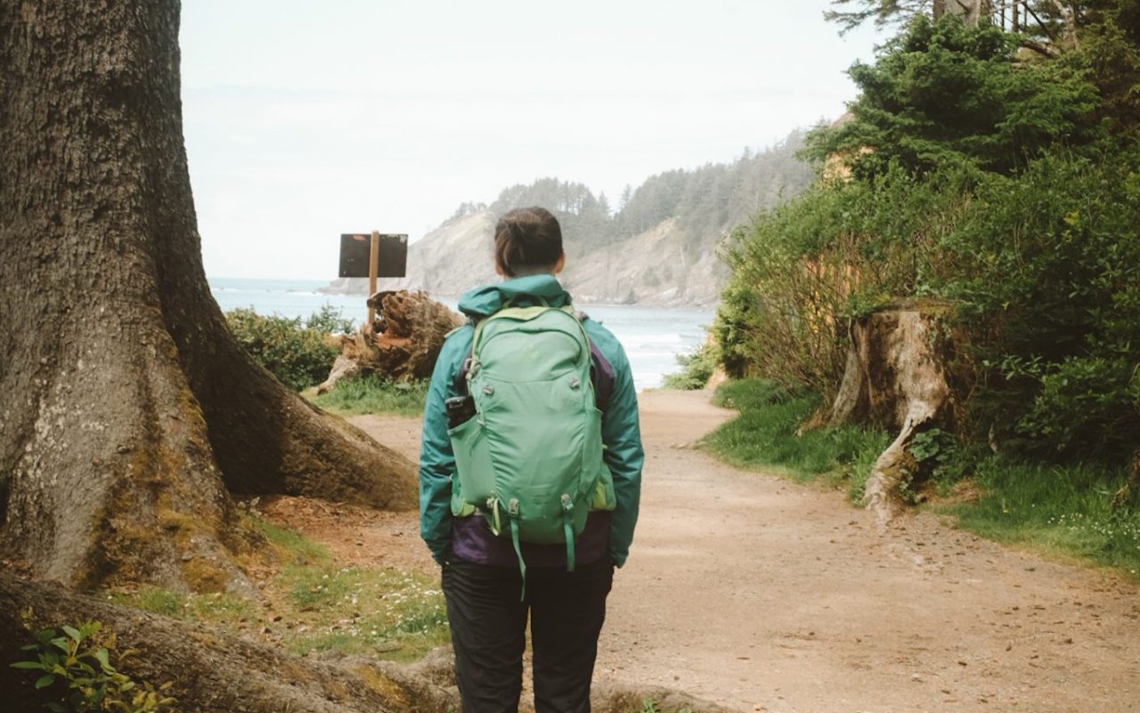 Hiker with a backpack on a forest trail