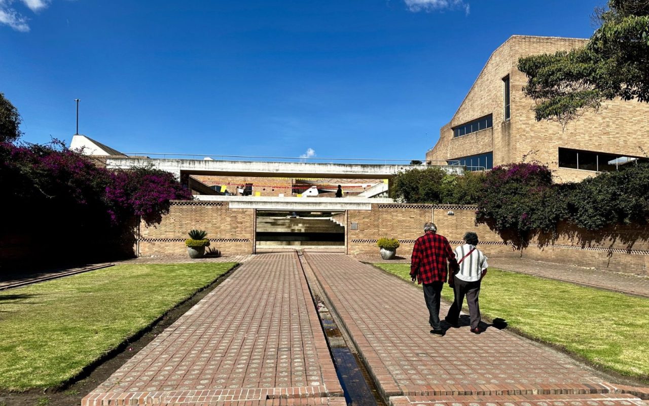 Two people walking along a garden path